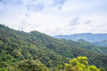 Scenic view of mountains against cloud sky