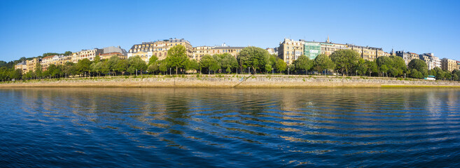 Fototapeta premium The city of Donostia is reflected in the Urumea river, Euskadi