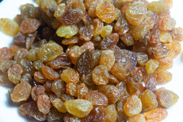 Dried yellow raisins fruit isolated on white background close up