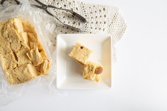 Soan papdi or patisa is a popular Indian dessert, it is cut in cube-shaped or served as flakes, and has a crisp and flaky texture.