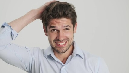 A close-up view of a puzzled young man is shrugging his shoulders standing isolated over white background - Powered by Adobe