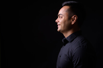 Portrait of happy young handsome Indian businessman