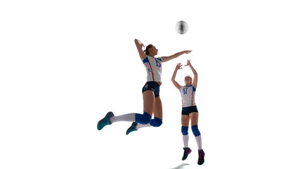Plakat Female professional volleyball players in action on white background.