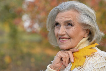 Portrait of happy senior beautiful woman in park