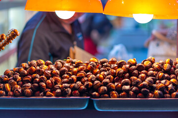 Selective focus shot of roasted chestnut in shop shelf