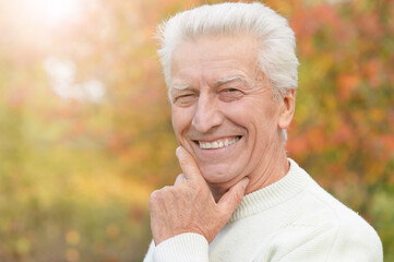 Portrait of smiling senior man in park