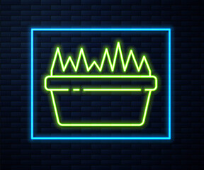 Glowing neon line Fresh grass in a rectangular icon isolated on brick wall background. Home decor. The symbol of growth and ecology. Vector Illustration.