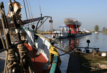 Fototapeta na wymiar Transport superyacht. Netherlands. Sailing yacht. Shipbuilding industry. Zwartewater river Zwartsluis.