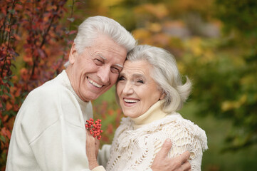 Beautiful senior couple with rowan in the park