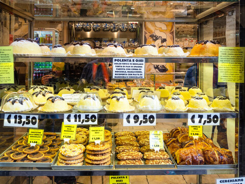 BERGAMO, ITALY - FEBRUARY 23, 2019: window of pastry store with traditional local products including Polenta e osei dish in Citta Alta (Upper Town) of Bergamo city, Lombardy