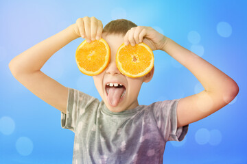 two orange slices of fresh, juicy oranges holding a cheerful kid in their hands on a bright background, the concept of a healthy diet, vitamins, lifestyle