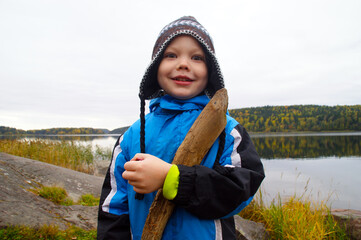 happy boy on coast lake