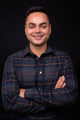 Portrait of happy young handsome Indian hipster man