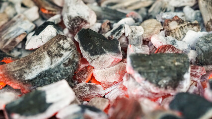 Coals, embers and fire burning in the barbecue