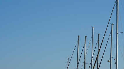 Sailing yacht masts at sea sunny day and sky