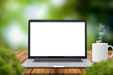 Laptop with blank screen on Wooden table with, coffee mug with smoke, blurred nature green background of bokeh.