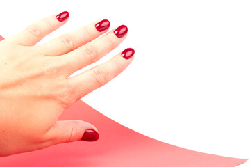 Stylish trendy female manicure. red manicure nails on red and white background