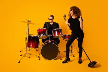 Photo of cool rock group handsome guy playing drum instruments crazy girl sing retro old fashion...