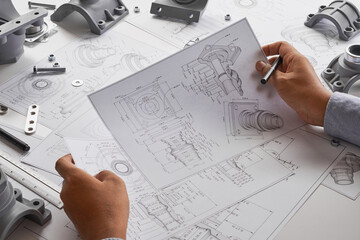 Engineer technician designing drawings mechanical parts engineering Engine.manufacturing factory Industry Industrial work project blueprints measuring bearings caliper tools
