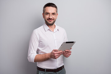Portrait of his he nice attractive intellectual content mature man holding in hands ebook analyzing...