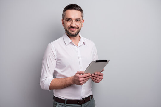 Portrait Of His He Nice Attractive Intellectual Content Mature Man Holding In Hands Ebook Analyzing Review Report Isolated Over Light Gray Pastel Color Background