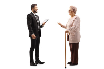 Elderly woman talking to a young elegant man in a suit