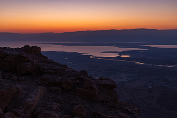 Obraz premium Dawn over the mountains of Jordan and the Dead Sea. View from the territory of the ruins of the Massada fortress in Israel.