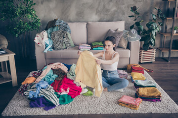 Top above high angle view photo of focused girl sit carpet legs crossed folded order her tidy casual dressing decide what sale in house indoors