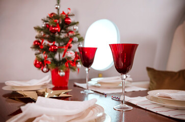 table with plates and red glasses Christmas tree ,the cabin of the aircraft