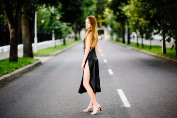 portrait beautiful girl in black dress outdoors