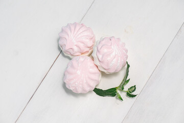 homemade berry marshmallow on a white plate with a mint leaf