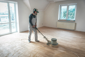worker with professional polishing machine