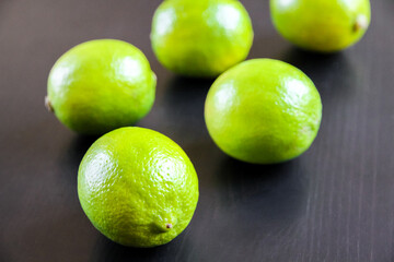 Group of fresh organic limes on a black background