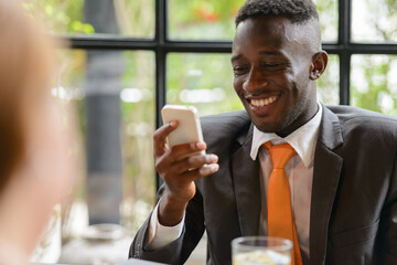 Young African businessman and young businesswoman together
