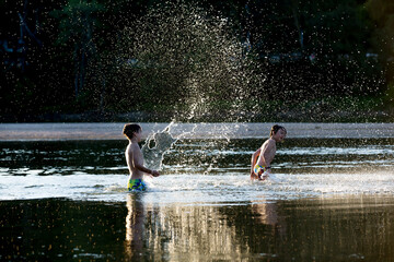Beautiful portrait of children in lake, kids playing in the water