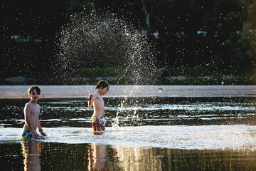 Beautiful portrait of children in lake, kids playing in the water