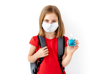 Schoolgirl in medical mask holding sanitizer