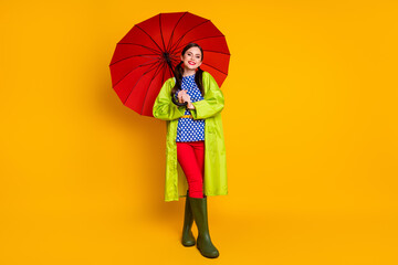 Full length body size view of her she nice attractive cheerful cheery glad fashionable girl wearing green raincoat open parasol isolated bright vivid shine vibrant yellow color background