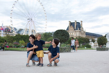 Obraz premium Happy children, boy brothers, visiting Paris during the summer