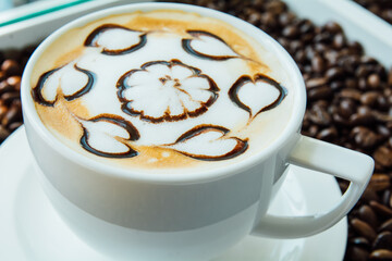 Latte art, Close up of a beautiful cup of hot coffee on coffee bean background