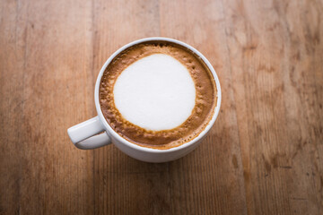 hot coffee with foam milk art, latte art coffee ( Filtered image processed vintage effect.)