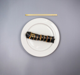 Gimbap (Korean Seaweed Rice Rolls) - with chop sticks, focus on top rolls