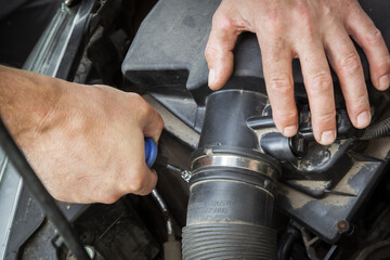 Close-up Of Hand Repairing Car Engine.