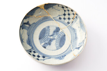 Japanese kintsugi ceramic bowl restored with real gold. Antique pottery kintsukuroi.