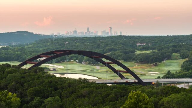 Time Lapse of Iconic Bridge in Austin Texas with Lake and Skyline in the background