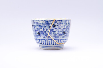 Fototapeta premium Japanese kintsugi ceramic teapot restored with real gold. Antique pottery kintsukuroi.