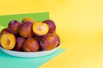 Fresh plums are yellow-red. Juicy and large. Purchase of goods for future use. Vitamins for immunity. On a light background.