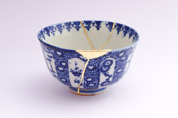 Japanese kintsugi ceramic chawan bowl restored with real gold. Antique pottery kintsukuroi.