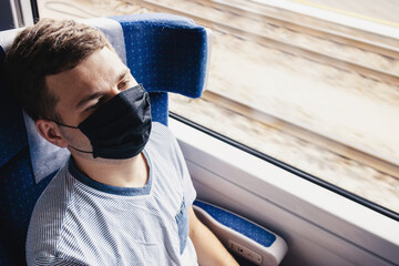 Young man wearing protective face mask sitting in the traing