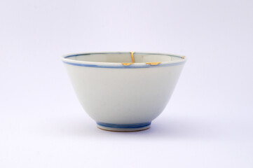 Japanese kintsugi ceramic teapot restored with real gold. Antique pottery kintsukuroi.
